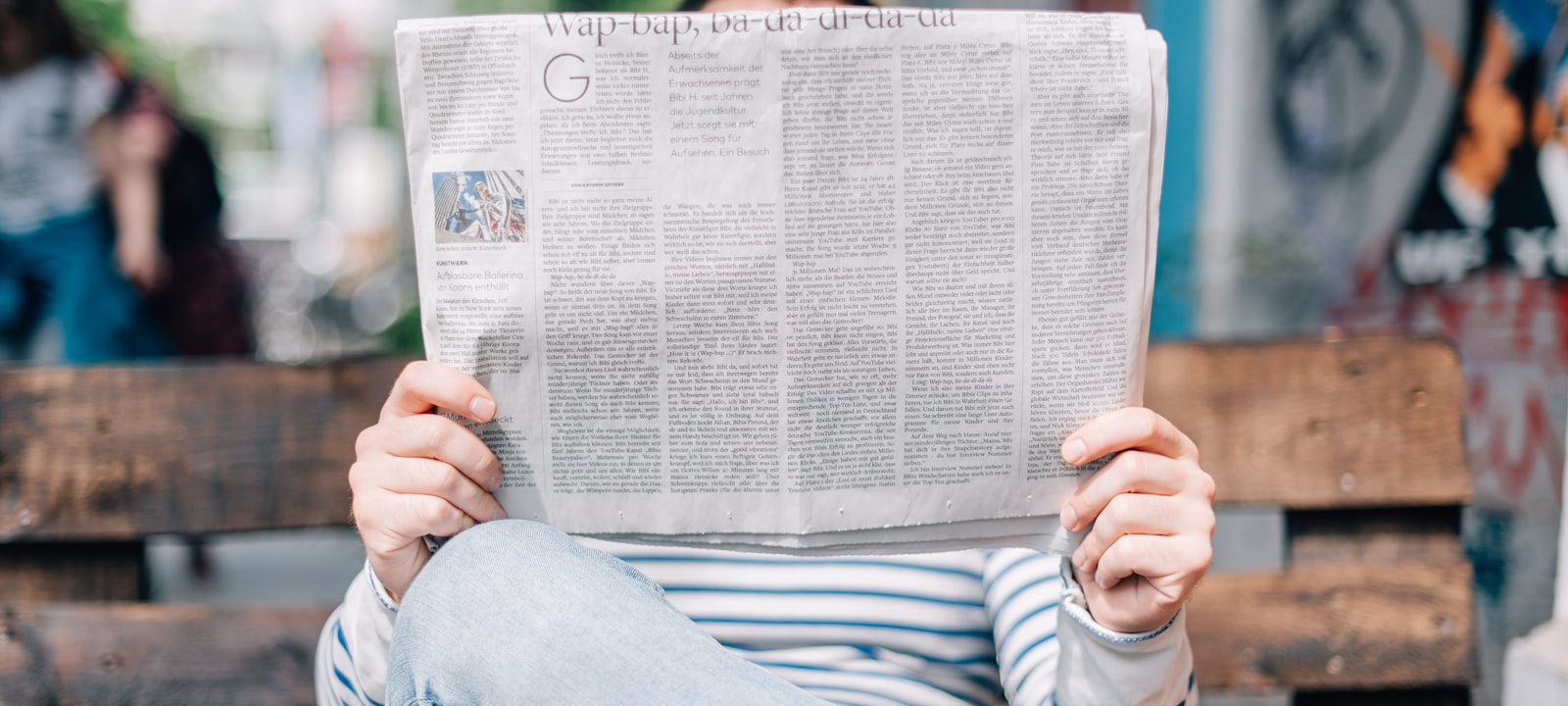 Stack of printed newspapers fanned out on a table